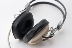 Over-ear headphones with black padded ear cups and a light-colored frame on a white background.